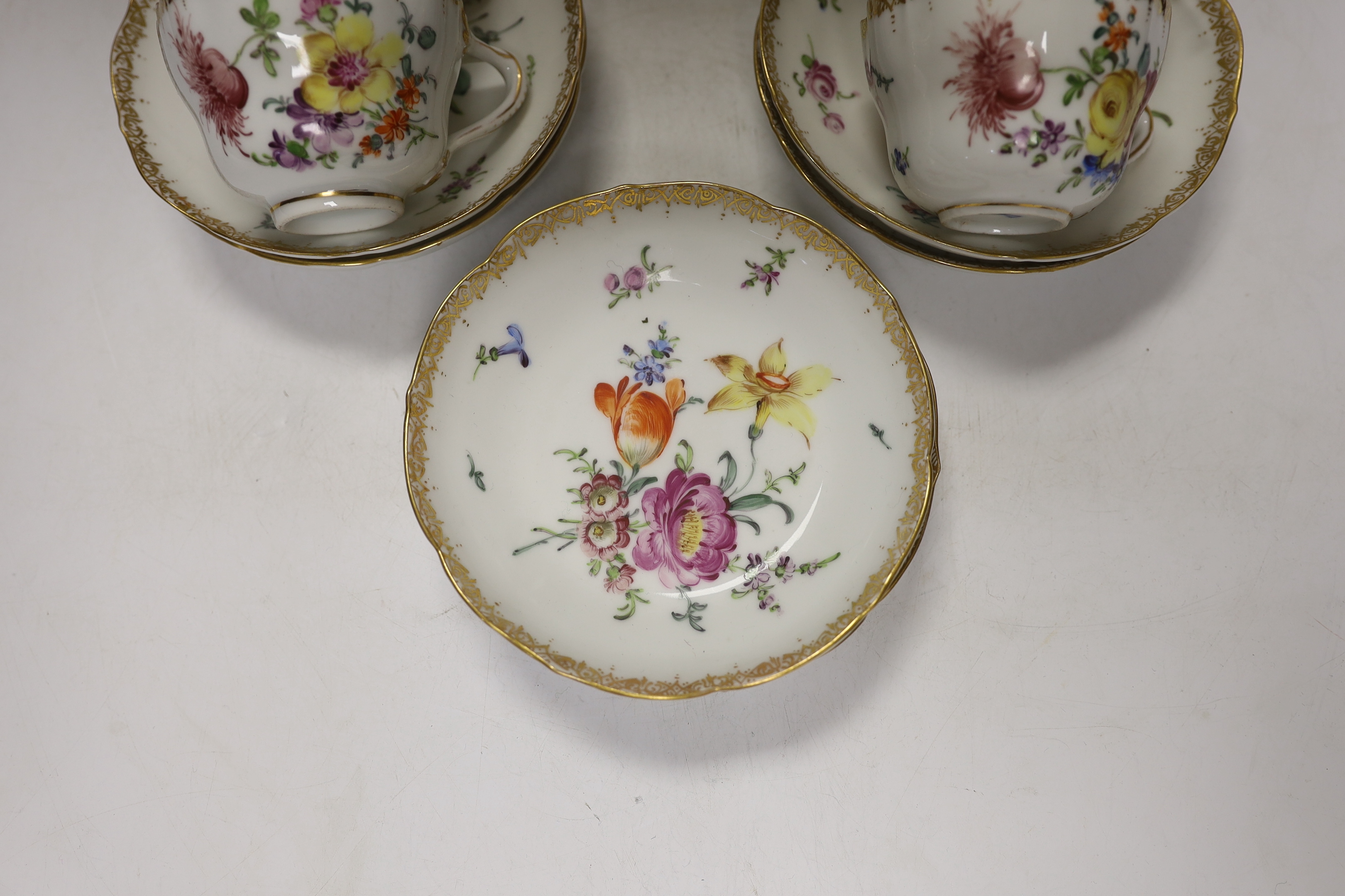 Twelve early 20th century Dresden floral tea cups and saucers